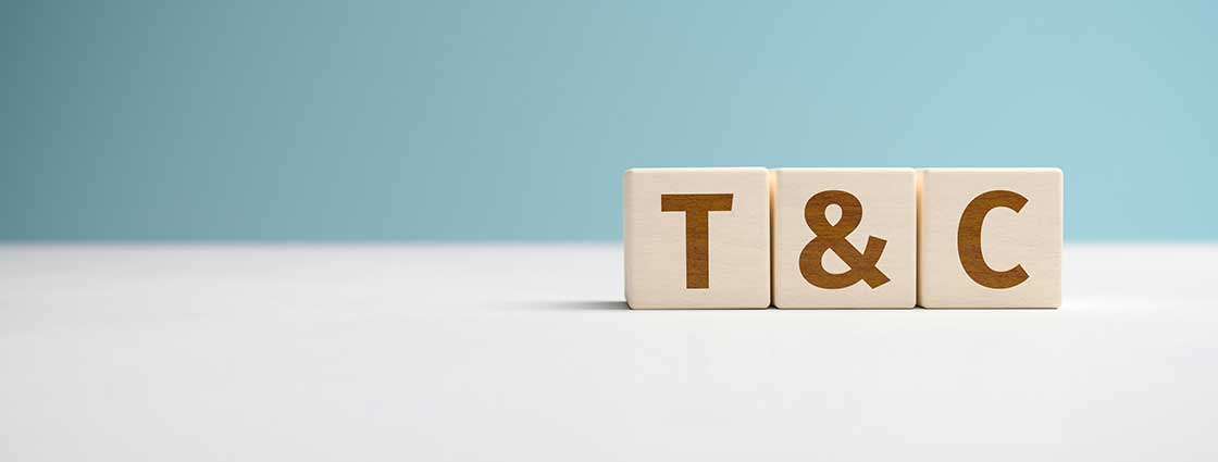 Wooden blocks on white table spelling out 'T&C'